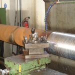 Rough machining of 2-stroke piston rod surface prior to final reconditioning at KIMI workshop.