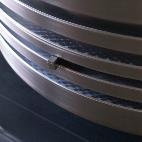Certified KIMI technician performing NDT inspection on reconditioned piston crown grooves.