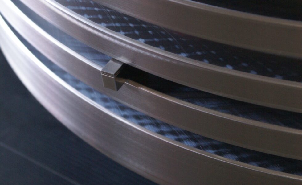 Certified KIMI technician performing NDT inspection on reconditioned piston crown grooves.