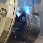 AI-driven robotic welding restoring 2-stroke piston crown grooves at KIMI’s advanced reconditioning facility.