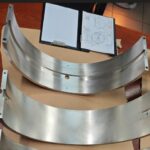 Upper and lower halves of 2-stroke engine bearing shells ready for assembly at KIMI’s workshop.