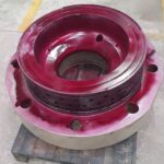KIMI technician performing dimensional and NDT inspection on reconditioned 2-stroke cylinder cover.