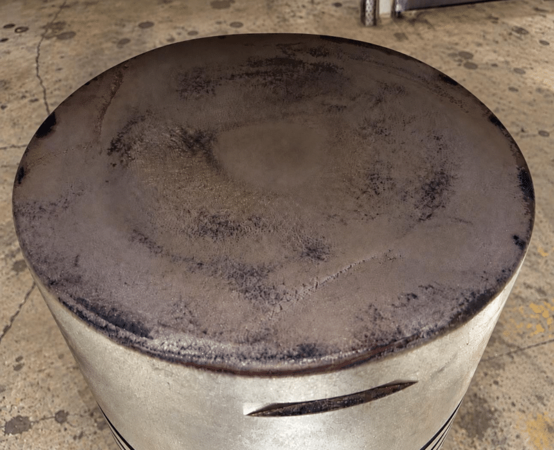 MAN B&W 5S60MC-C piston crown before reconditioning, showing combustion deposits, thermal discoloration and surface deterioration.